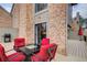 Outdoor seating area on a wooden deck with a brick house and trees in the background at 3716 Stonewall Se Cir, Atlanta, GA 30339