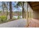 View of backyard area facing the lake, with a wooded landscape. Paved patio area at 3716 Stonewall Se Cir, Atlanta, GA 30339