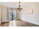 Dining room featuring hardwood floors, a modern chandelier, and sliding glass doors at 3716 Stonewall Se Cir, Atlanta, GA 30339