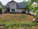 Large backyard features a patio, hot tub, swing set, patio furniture, and a well-maintained lawn at 3775 Pine Village Pl, Loganville, GA 30052