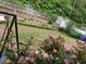 Beautiful backyard with lush plants and flowers blooming beside a white picket fence at 3775 Pine Village Pl, Loganville, GA 30052