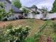 Large backyard featuring rose bushes and other plants and flowers along the fence line at 3775 Pine Village Pl, Loganville, GA 30052
