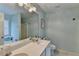 Bathroom with double sinks, a large mirror, and soft blue walls, great natural light at 3775 Pine Village Pl, Loganville, GA 30052