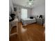 Cozy bedroom with hardwood floors, a ceiling fan, ample natural light and neutral walls at 3775 Pine Village Pl, Loganville, GA 30052