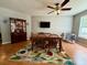 Inviting dining room with a wooden table set, decorative rug, and bright natural light at 3775 Pine Village Pl, Loganville, GA 30052