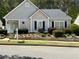 Charming single-story home with manicured landscaping and gray siding at 3775 Pine Village Pl, Loganville, GA 30052
