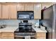 Kitchen featuring wooden cabinets, stainless steel appliances, and ample counter space at 3775 Pine Village Pl, Loganville, GA 30052