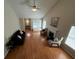 Vaulted living room featuring a cozy fireplace, hardwood floors, and bright windows at 3775 Pine Village Pl, Loganville, GA 30052