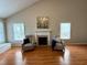 Bright living room with fireplace, comfortable seating, and abundant natural light at 3775 Pine Village Pl, Loganville, GA 30052