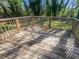 Inviting backyard deck perfect for outdoor relaxation and entertaining with a wooden safety rail and bright sunlight at 4665 Garden Hills Dr, Stone Mountain, GA 30083