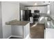 Modern kitchen features stainless steel appliances, granite countertops and lots of cabinet space at 4665 Garden Hills Dr, Stone Mountain, GA 30083