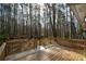 Wooden backyard deck surrounded by a forest of tall trees at 98 Brenda Cir, Rockmart, GA 30153