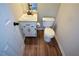 A half bath with wood look floors, a single sink, and a toilet at 98 Brenda Cir, Rockmart, GA 30153