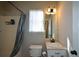 Bright bathroom with a shower-tub combo, vanity sink, and window for natural light at 98 Brenda Cir, Rockmart, GA 30153