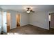 Bedroom with neutral walls, ceiling fan, carpeted floor, and closet and bathroom entrances at 98 Brenda Cir, Rockmart, GA 30153