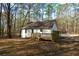 Charming home exterior with a wooden deck surrounded by woods at 98 Brenda Cir, Rockmart, GA 30153