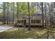 Quaint cottage-style home with a wooden porch, perfect for enjoying the wooded surroundings at 98 Brenda Cir, Rockmart, GA 30153