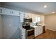 Well-equipped kitchen with white cabinets, stainless steel appliances, and practical laminate flooring at 98 Brenda Cir, Rockmart, GA 30153