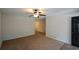 Spacious living room with neutral carpeting, ceiling fan, and access to the kitchen and entryway at 98 Brenda Cir, Rockmart, GA 30153