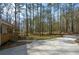 Property featuring ample parking with a charming home nestled in a wooded landscape at 98 Brenda Cir, Rockmart, GA 30153