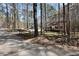 Idyllic home setting surrounded by a forest, with a glimpse of the welcoming front porch at 98 Brenda Cir, Rockmart, GA 30153