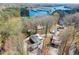 Aerial view of a home nestled among trees, overlooking a scenic lake with docks and boat slips at 2655 Lakeside Trl, Cumming, GA 30041