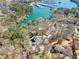 Aerial view of a lakeside home surrounded by mature trees with a personal dock and lake access at 2655 Lakeside Trl, Cumming, GA 30041