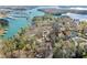 Aerial view of a lakeside home surrounded by mature trees and waterfront access at 2655 Lakeside Trl, Cumming, GA 30041
