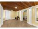 Spacious finished basement with wood-look flooring, a wooden ceiling, and access to a cozy living area at 2655 Lakeside Trl, Cumming, GA 30041