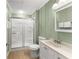 This bathroom features a toilet, vanity and a shower with sliding glass doors at 2655 Lakeside Trl, Cumming, GA 30041