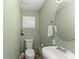 Powder room featuring a toilet, sink and decorative features at 2655 Lakeside Trl, Cumming, GA 30041