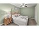Well-lit bedroom featuring a comfortable bed, neutral carpet, and night stand at 2655 Lakeside Trl, Cumming, GA 30041