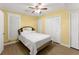 Bright bedroom featuring wood-look flooring, ample closet space, and soft, natural light at 2655 Lakeside Trl, Cumming, GA 30041