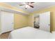 Bedroom with wood-look floors, a white comforter, and a glimpse into another room at 2655 Lakeside Trl, Cumming, GA 30041