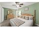Well-lit bedroom featuring a comfortable bed, neutral carpet, and dresser at 2655 Lakeside Trl, Cumming, GA 30041