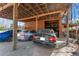 Carport with three parked cars, featuring a wooden structure and a gravel surface at 2655 Lakeside Trl, Cumming, GA 30041