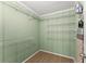 Walk in closet with light green wood paneling and wire shelving at 2655 Lakeside Trl, Cumming, GA 30041
