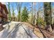 Gravel driveway leading to a wooded lot with a glimpse of the house to the left in a serene, wooded setting at 2655 Lakeside Trl, Cumming, GA 30041