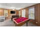Game room with a foosball and pool table, neutral carpet, and wood paneled walls at 2655 Lakeside Trl, Cumming, GA 30041