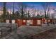 Exterior view of a cozy home with a charming yard, featuring a classic white picket fence and warm lighting at 2655 Lakeside Trl, Cumming, GA 30041