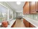 Bright kitchen with a breakfast nook, wood cabinets and ample natural light from multiple windows at 2655 Lakeside Trl, Cumming, GA 30041