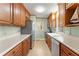 Kitchen with stainless steel appliances and warm-toned cabinetry at 2655 Lakeside Trl, Cumming, GA 30041
