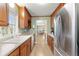 Galley kitchen featuring stainless steel appliances, wood cabinets, and a bright double-basin sink at 2655 Lakeside Trl, Cumming, GA 30041