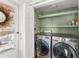 A laundry room with a side door and laundry machines at 2655 Lakeside Trl, Cumming, GA 30041