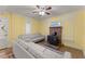 Comfortable living room with yellow walls, wood-look flooring, and a charming brick fireplace with a wood-burning stove at 2655 Lakeside Trl, Cumming, GA 30041