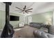 Cozy living room featuring a decorative fireplace, carpeted floors, and comfortable gray sofa at 2655 Lakeside Trl, Cumming, GA 30041