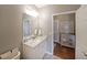 Bathroom features a granite vanity, large mirror, and access to the main bedroom at 4805 W Village Se Way # 1302, Smyrna, GA 30080