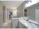 Modern bathroom with double granite vanity and access to the shower and walk-in closet at 4805 W Village Se Way # 1302, Smyrna, GA 30080