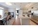 Open-concept layout with a fireplace, dining area, and kitchen featuring an island with granite countertops at 4805 W Village Se Way # 1302, Smyrna, GA 30080