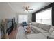 Cozy living room with a ceiling fan, large windows, and a comfortable sectional sofa at 4805 W Village Se Way # 1302, Smyrna, GA 30080
